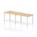 This image features a spacious desk with a maple top and white frame, designed for two people in a dynamic office setting. The bench desking system promotes collaboration and efficiency, with a sleek and modern aesthetic.
