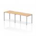 This photograph showcases a sleek and modern Dynamic Bench Desking Evolve Plus desk. The maple top and silver frame add a touch of elegance, while the single row design makes it perfect for two individuals to work comfortably side by side.