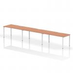This photograph showcases a dynamic bench desking system called Evolve Plus. It features a 1600mm single row, with space for 3 people. The desk has a sleek beech top and a white frame, creating a modern and professional look for any office space.