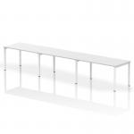 The photograph showcases a modern and sleek Dynamic Bench Desking Evolve Plus 1400mm Single Row 3 Person Office Bench Desk, with a white top and white frame. The desk has a spacious and versatile design, perfect for collaborative work in a professional environment.