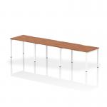 This image features a sleek, modern office space with a single row of dynamic bench desks. The desks, measuring 1200mm, are finished with a polished walnut top and a clean white frame. The layout comfortably accommodates three people, creating a collaborative and efficient work environment.