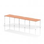 The photo shows a sleek and modern Dynamic Bench Desking Evolve Plus desk, featuring a beech top and white frame. The 1200mm size accommodates three people in a single row for a collaborative workspace.
