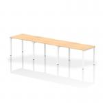This photograph captures a sleek and modern office space with the Dynamic Bench Desking Evolve Plus desk. The 1200mm single row layout comfortably accommodates 3 people and features a maple top and white frame, adding a touch of elegance to the workspace.
