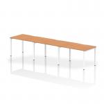 This picture features a sleek and functional Dynamic Bench Desking Evolve Plus 1200mm Single Row 3 Person Office Bench Desk. The desk has an oak top and a white frame, providing a modern and stylish look. Its spacious design allows for optimal productivity and collaboration in a shared office space.