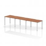 The picture features a sleek 1200mm single row dynamic bench desking system with walnut top and silver frame, designed for 3 persons in a modern office setting. The clean lines and versatile design make this desk ideal for collaborative workspaces.