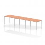 This image shows a dynamic bench desking setup, the Evolve Plus 1200mm single row 3 person office bench desk. It features a beech top and a silver frame, creating a sleek and modern look. The open design allows for collaboration and efficient use of space in the office.