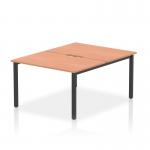 The photo shows a modern and stylish 2 person office bench desk with a beech top and black frame. The dynamic bench desking offers plenty of workspace for productivity and organization.
