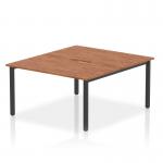In the photograph, the Dynamic Bench Desking Evolve Plus features a sleek and modern design with a 1400mm B2B 2 person office bench desk. The walnut top complements the black frame, creating a professional and stylish workspace.