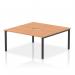 In the photo, two people can be seen working on the Dynamic Bench Desking Evolve Plus, with a spacious 1600mm oak top and sturdy black frame. The bench desk is designed for 2 person use, providing a sleek and functional addition to any office space.