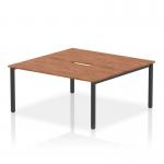 This is a picture of a sleek and modern bench desk, the Dynamic Bench Desking Evolve Plus 1600mm. It features a stylish walnut top and a sturdy black frame, perfect for accommodating two people in a professional office setting.