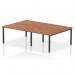 The image shows a sleek and modern dynamic bench desking system, featuring a walnut top and black frame. The 1200mm B2B design allows for 4 person seating, making it perfect for a contemporary office setting. With its clean lines and functional design, this desk is both stylish and practical.