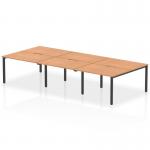 The photo features a spacious and modern Dynamic Bench Desking Evolve Plus 1200mm B2B 6 Person Office Bench Desk. Its sleek black frame contrasts beautifully with the warm oak top, creating a professional and stylish work space for multiple team members.