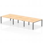 This photo features a sleek and modern Dynamic Bench Desking Evolve Plus 1400mm with a Maple Top and Black Frame. The desk is designed for 6 people and has a clean and organized appearance, perfect for a professional office setting.