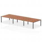 This photo captures a modern office setting featuring a 1600mm B2B 6-person bench desk with a sleek walnut top and black frame. The dynamic design of the desk allows for versatility and collaboration among team members.