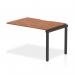This photograph captures the sleek and functional design of the Dynamic Bench Desk Add On Units Evolve Plus. 1200mm Single Row Office Bench Desk Ext Kit in a rich walnut top and black frame. The versatile desk provides ample workspace for any office setting.