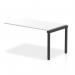This photograph features the Evolve Plus 1400mm Single Row Office Bench Desk Ext Kit, with a sleek white top and contrasting black frame. The dynamic bench desk add on units provide additional working space and organization for a modern and efficient office environment.