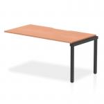 This image features a sleek and modern Dynamic Bench Desk Add On Unit from the Evolve Plus collection. The unit is 1600mm long and constructed with a single row of office bench desks. The top is a beautiful beech color and is supported by a sturdy black frame.