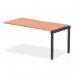 This image features a sleek and modern Dynamic Bench Desk Add On Unit from the Evolve Plus collection. The unit is 1600mm long and constructed with a single row of office bench desks. The top is a beautiful beech color and is supported by a sturdy black frame.