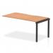 The photograph showcases the sleek and modern design of the Dynamic Bench Desk Add On Units Evolve Plus 1600mm Single Row Office Bench Desk Ext Kit. The oak top and black frame create a sophisticated and professional look, perfect for any office space.