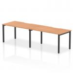 The image shows a sleek and modern office bench desk, measuring 1400mm in length and designed for two people. The desk features a beautiful oak top and a sturdy black frame, exuding a sense of sophistication and style. Its dynamic design allows for a versatile and efficient workspace.
