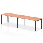 This picture captures the sleek and modern design of the Dynamic Bench Desking Evolve Plus 1600mm Single Row 2 Person Office Bench Desk. The beech top and black frame create a stylish contrast, while the spacious work area and additional shelf provide ample storage space. Perfect for any modern workplace.