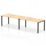 This image shows a modern 1600mm single row office bench desk with a maple top and black frame. The design features a dynamic, functional style, with enough space for two people to work comfortably. Ideal for a professional and versatile office setting.