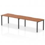 The picture features a sleek and modern Dynamic Bench Desking Evolve Plus, measuring 1600mm in length and designed for 2 people. The walnut top adds a touch of warmth, while the black frame exudes sophistication. This is the ideal office bench desk for a dynamic and stylish workspace.