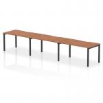 This photo captures the sleek and modern design of the Dynamic Bench Desking Evolve Plus 1400mm Single Row 3 Person Office Bench Desk. Its walnut top and black frame give it a sophisticated look, while its 3-person capacity makes it suitable for a collaborative workspace.