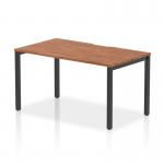 The image shows a modern and stylish Dynamic Bench Desk Starter Unit from the Evolve Plus collection. Its 1400mm walnut top contrasts beautifully with the sleek black frame, adding a touch of elegance to any office space. This single starter office desk is designed for maximum functionality and adaptability, making it the perfect addition to any workspace.