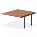 This picture shows a stylish and modern office setup with Dynamic Bench Desk Add On Units from the Evolve Plus series. The 1400mm B2B Office Bench Desk Ext Kit features a walnut top and sleek black frame, adding functionality and sophistication to any workspace.