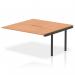 The photograph captures a sleek and modern office environment with the Dynamic Bench Desk Add On Units Evolve Plus. The 1600mm B2B Office Bench Desk Ext Kit features an elegant oak top and stylish black frame, creating a professional and sophisticated workspace.