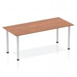 This image shows a sleek and modern Dynamic Tables Impulse 1800mm Straight Table with a rich walnut top and silver post legs. The table is ready to provide a functional and stylish workspace for any office or meeting room.