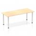 The image shows a long, rectangular table with a maple wood top and silver metal legs. The table has a sleek, modern design and appears to be sturdy and well-crafted. The silver post legs add a touch of elegance to the otherwise simple and functional table.