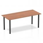 This image shows a 1800mm straight table, featuring a rich walnut top and sleek black post legs. The dynamic design creates a modern and stylish look, perfect for any contemporary workspace.