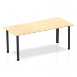 The photo shows a sleek and modern Dynamic Tables Impulse 1800mm straight table. The maple top complements the black post legs, adding a stylish touch to any space. Perfect for offices or workspaces, this table exudes elegance and functionality.