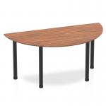 This photo showcases a sleek and modern Dynamic Tables Impulse 1600mm Semi-Circle Table with a beautiful walnut top and bold black post legs. The semi-circle shape adds a unique touch to any space, and the rich wood finish adds warmth and sophistication.