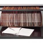 The photo features a Bisley Cupboard and Bookcase Accessories Qube, complete with a Lateral Filing Frame. The modern, sleek design of the Qube is evident, with a sturdy frame and multiple shelves and compartments for organizing files and other items. The Bisley brand name can be seen on the metal handles and frame. The overall look is functional and professional, perfect for a home office or workplace setting.