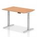 This picture features a stylish office desk with an oak top and silver legs. The desk is 1200 x 800mm and can be easily adjusted to a standing or sitting position to promote a more dynamic work experience.