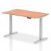 This picture shows a sleek, modern office desk measuring 1400 x 800mm. The desk is height adjustable, with a beech top and silver legs. It also features cable ports for easy organization. Perfect for a dynamic and ergonomic workspace.