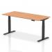 This picture shows a sleek and modern Dynamic Sit Stand and Height Adjustable Desk with an oak top and black legs. The desk measures 1800 x 800mm and can be adjusted to your preferred height. Perfect for any office space in need of versatility and style.
