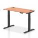 The photo showcases a spacious 1200 x 600mm desk with a sleek beech top and modern black adjustable legs. The desk is equipped with convenient cable ports and can be easily adjusted for sitting or standing, making it suitable for any office setting.