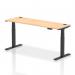 This picture features a sleek, modern office desk measuring 1800 x 600mm. The maple top is complemented by black legs, and the desk is equipped with cable ports for convenient organization. It is also height adjustable, allowing for dynamic sit stand options.
