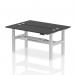 The photo features two sleek, black top bench desks connected in a back-to-back configuration. Each desk has a cable port for easy organization and a silver frame for a modern touch. The desks are also height adjustable, allowing for dynamic work setups.