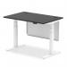 This picture features a sleek and modern Dynamic Sit Stand and Height Adjustable Desk. The desk measures 1200 x 800mm and has a black top, white legs, and a white steel modesty panel. It also includes convenient cable ports for organization.