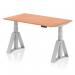 This picture features a sleek and modern office desk, measuring 1400 x 800mm, with a beech top and silver legs. The desk is height adjustable, allowing for both sitting and standing positions, and includes a unique Piste Foot for added stability and style.
