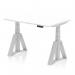 The photograph shows a sleek and modern office desk, with a white top and silver legs. It has an adjustable height feature, as well as a dynamic sit stand option, and is 1200 x 800mm in size. The desk also has a Piste Foot for added stability.