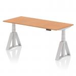 This photo showcases a beautiful Dynamic Sit Stand and Height Adjustable Desk. The desk features a stylish oak top and silver legs with a Piste foot for stability. The desk measures 1800 x 800mm and is perfect for any modern office space. It is easily adjustable to accommodate different sitting and standing positions.