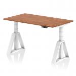 This picture shows a dynamic sit stand and height adjustable desk with a 1400 x 800mm walnut top and white legs. The desk also features a piste foot for added support.