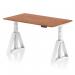 This picture shows a dynamic sit stand and height adjustable desk with a 1400 x 800mm walnut top and white legs. The desk also features a piste foot for added support.