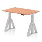 The photograph shows a sleek and modern office desk with a 1200 x 800mm beech top and silver legs. The desk is height adjustable and features cable ports and a piste foot for added convenience. The dynamic sit stand design allows for versatile use throughout the workday.